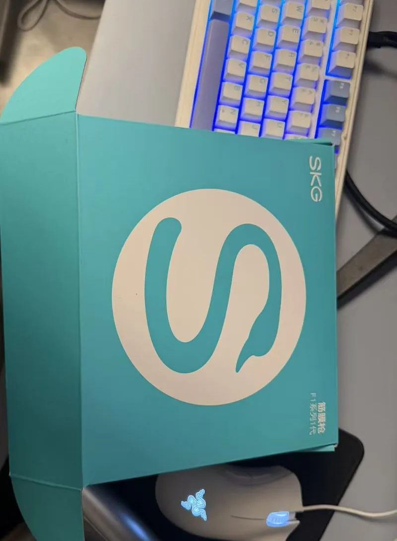 SKG F1 massage gun retail box in teal with the white SKG S logo