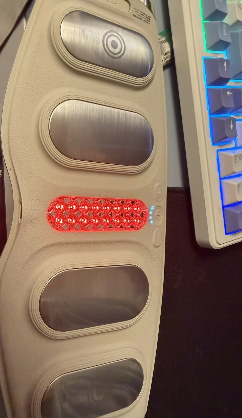 Inner side of the SKG G5 waist massager with metal EMS pads and the red heat element glowing